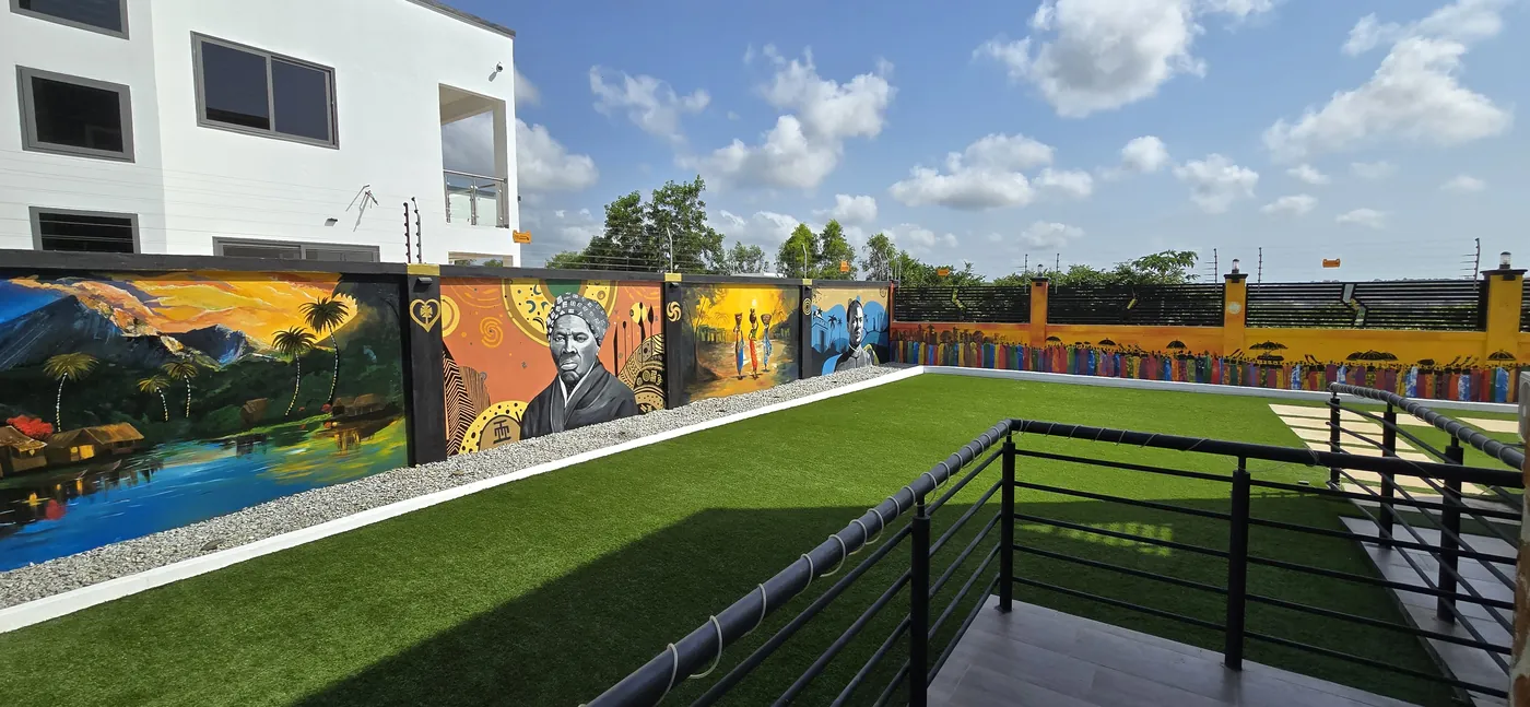 Rooftop terrace with railing, murals and blue sky